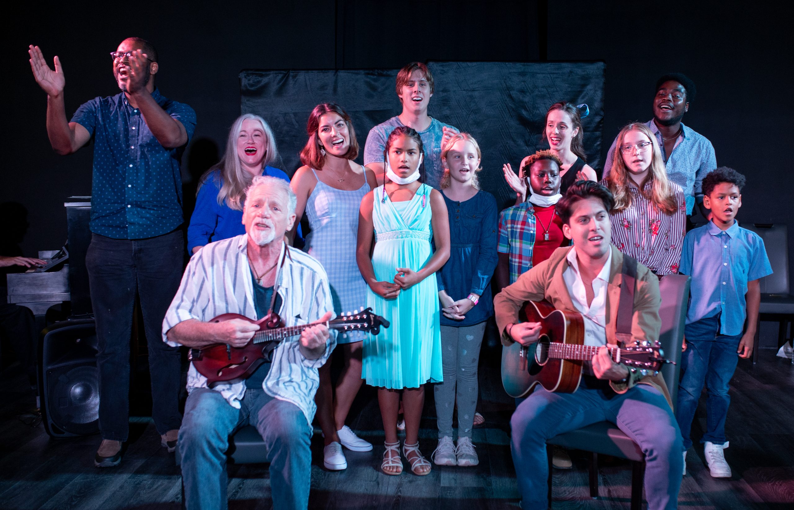 A group of individuals singing and celebrating.